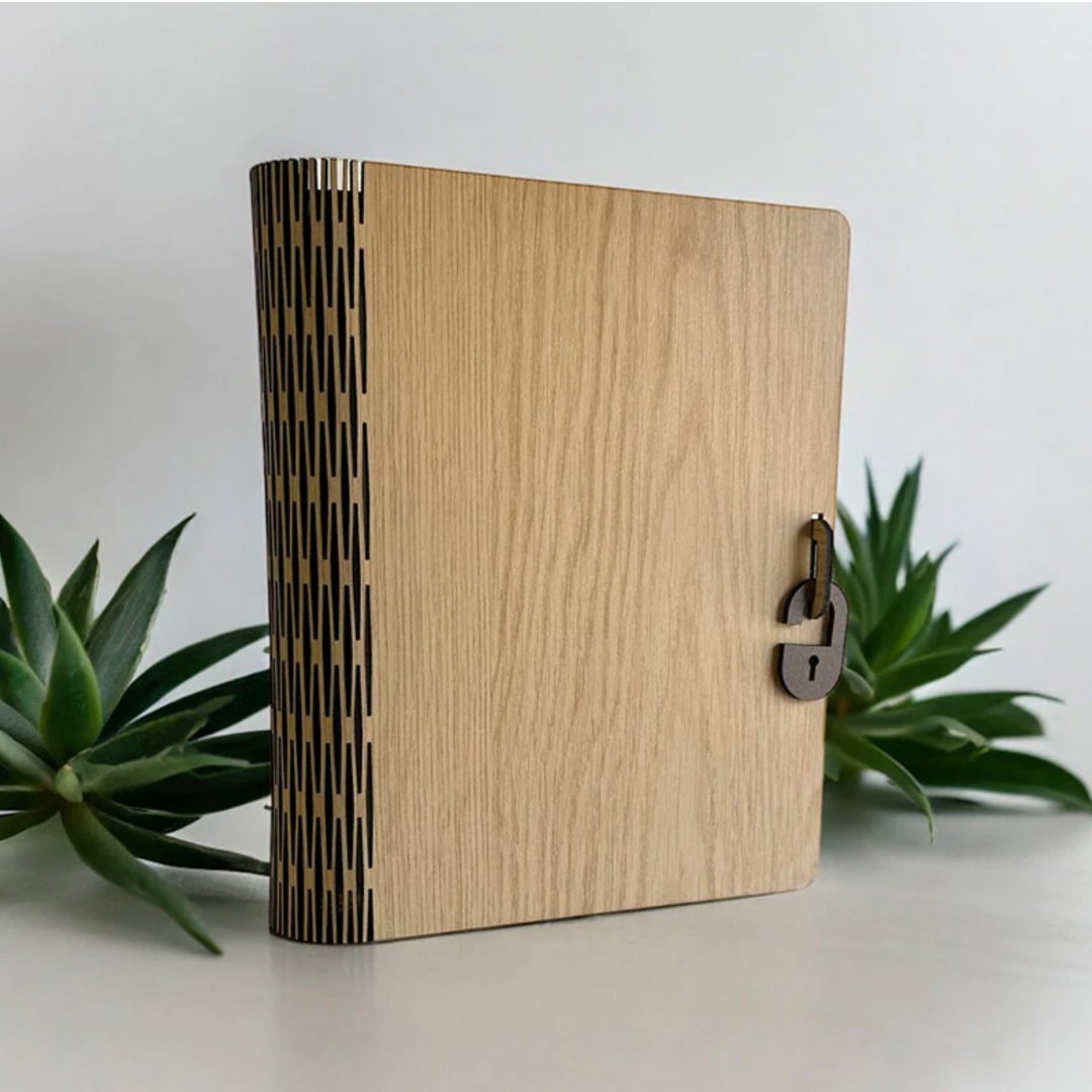 An laser cut book-like box with a bendable spine made on a laser cutter machine. Made from Truflat engineered wood. Sold by Thunder Laser Canada