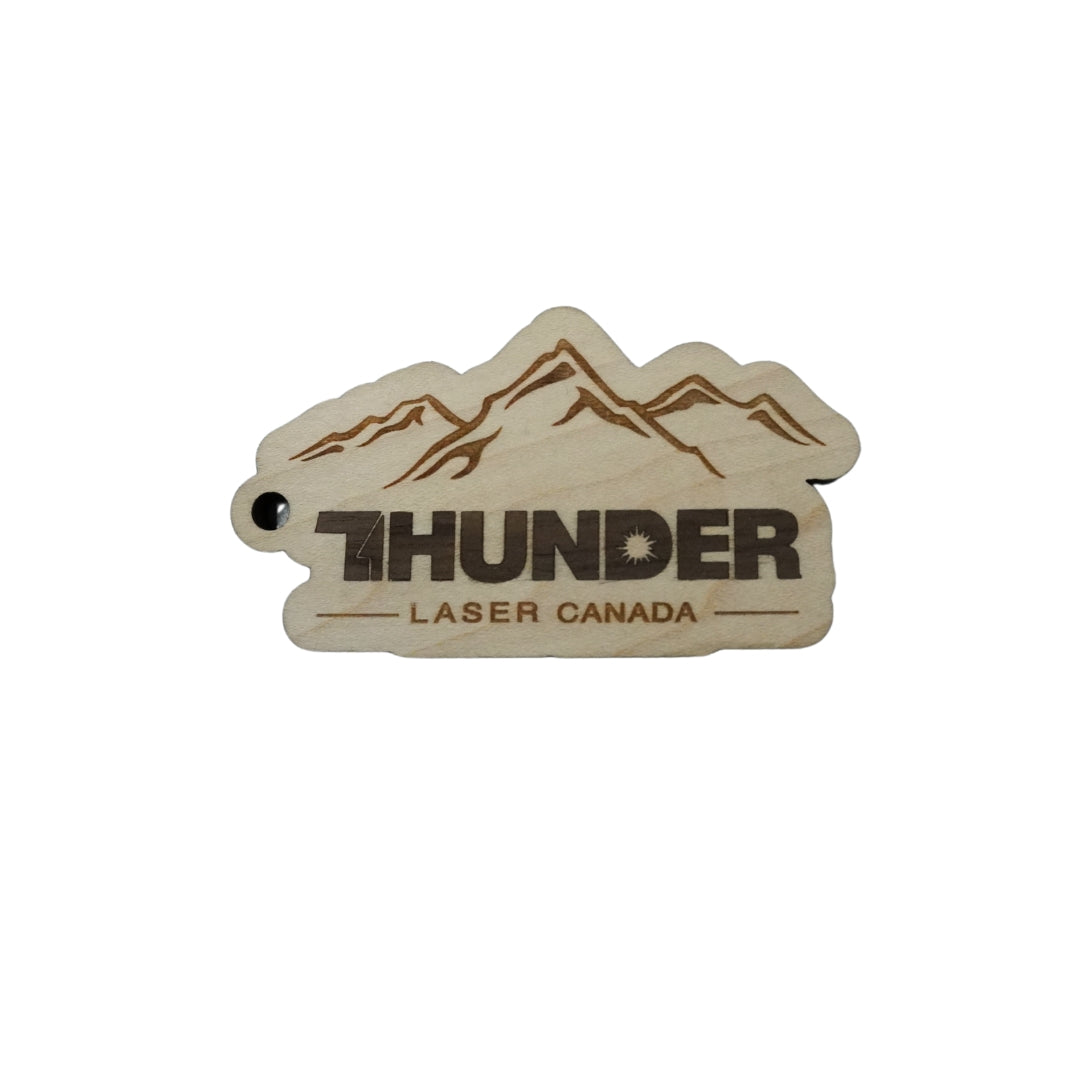 Thunder Laser Canada logo keychain  with mountains above the logo made with Baltic Birch with an thin walnut inlay.